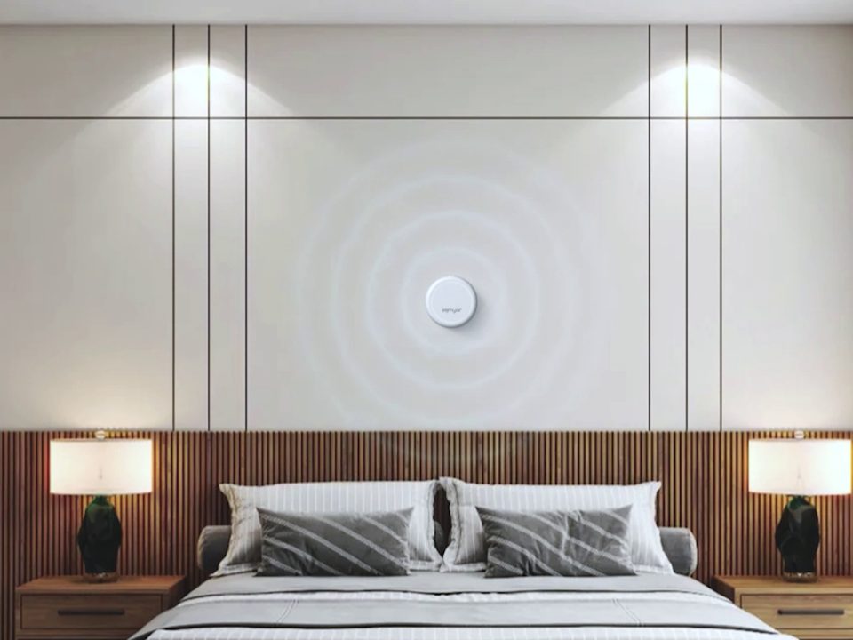 A Seenyor sensor mounted on a bedroom wall above the bed